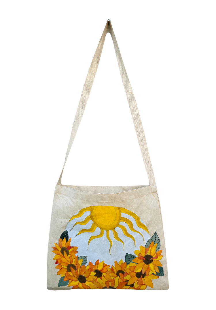 canvas tote bag with round painting of sunflowers and sun