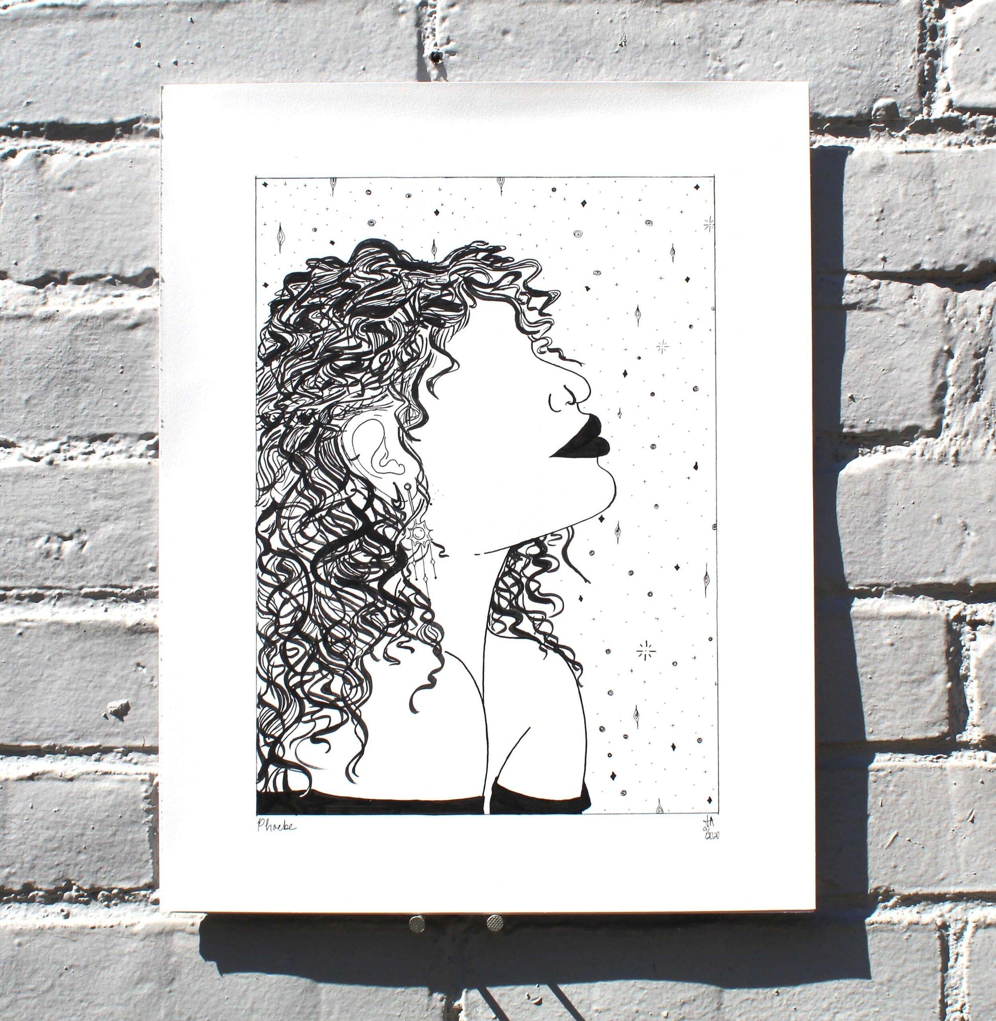 black and white drawing of woman with nose ring and curly hair on grey brick wall