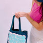woman holding denim acrylic painted bag 
