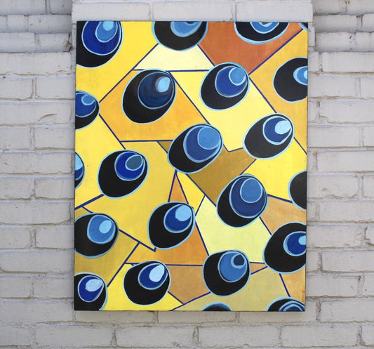 blue and yellow pattern of rectangular shapes and circular shapes on top on grey brick wall