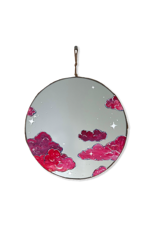 Round mirror painted with pink clouds and white stars